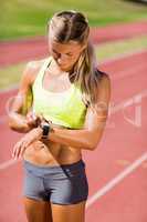 Female athlete checking her smart watch