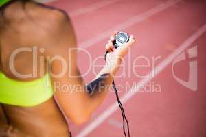 Mid-section of female athlete checking her smart watch