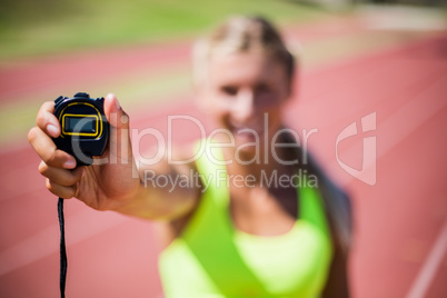 Female athlete showing stop watch