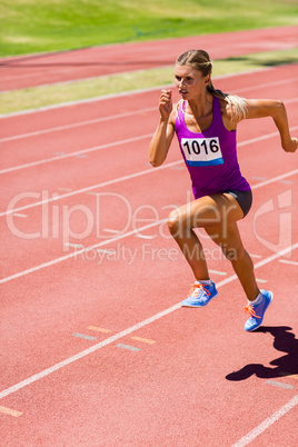 Female athlete running on the racing track