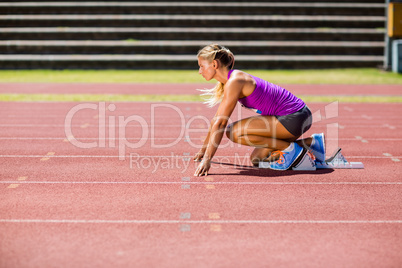 Female athlete ready to run on running track