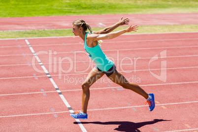 Female athlete running on the racing track