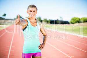 Happy female athlete showing thumbs up