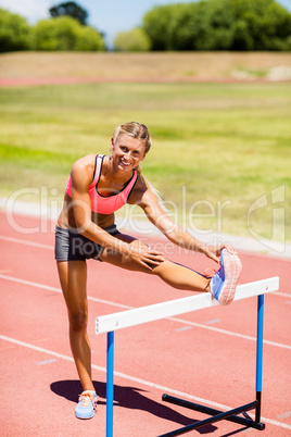 Portrait of female athlete warming up in stadium