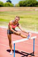 Portrait of female athlete warming up in stadium