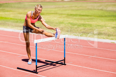 Female athlete warming up on running track