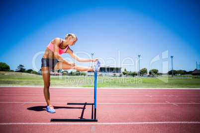 Female athlete warming up on running track