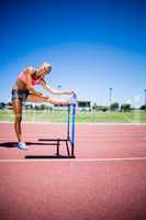 Portrait of female athlete warming up in stadium