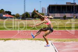 Female athlete performing a long jump