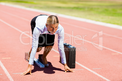 Businesswoman with briefcase ready to run