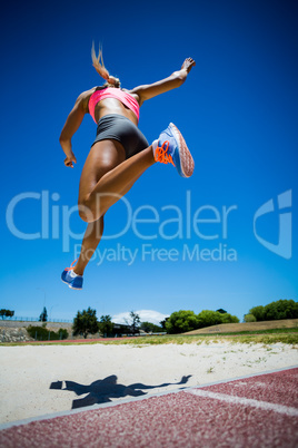 Female athlete performing a long jump