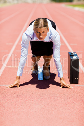 Businesswoman with briefcase ready to run