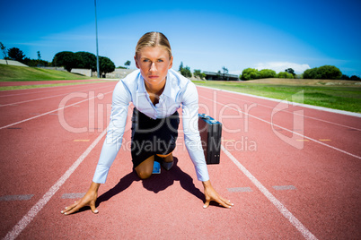 Portrait of businesswoman with briefcase ready to run