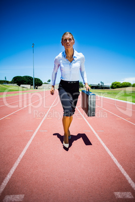 Businesswoman running on a running track