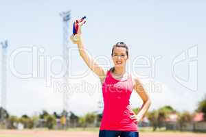 Portrait of female athlete showing her gold medals