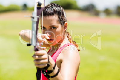 Female athlete practicing archery