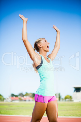 Excited female athlete posing after a victory