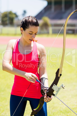 Female athlete practicing archery