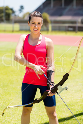 Female athlete practicing archery