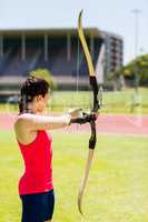 Female athlete practicing archery