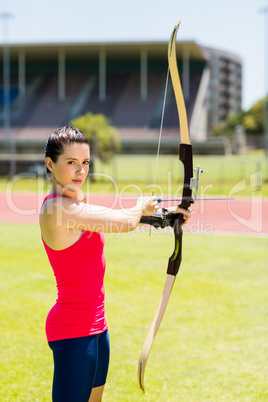 Female athlete practicing archery