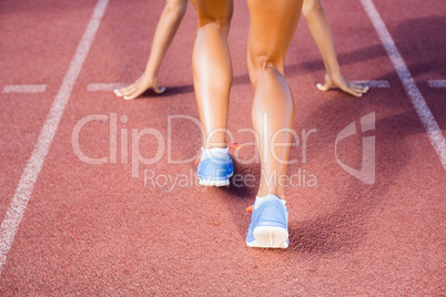 Female athlete ready to run on running track