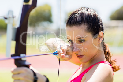 Female athlete practicing archery