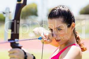 Female athlete practicing archery