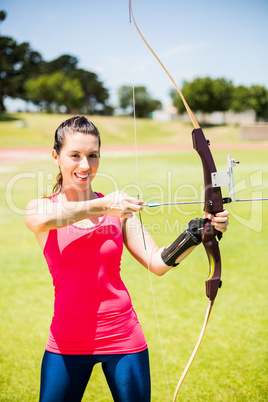 Female athlete practicing archery