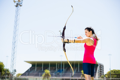 Female athlete practicing archery