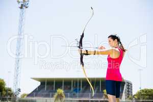 Female athlete practicing archery