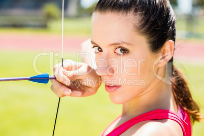 Female athlete practicing archery