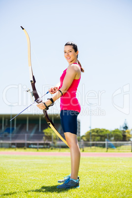 Female athlete practicing archery