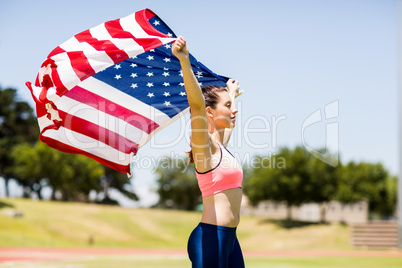Female athlete holding an american flag