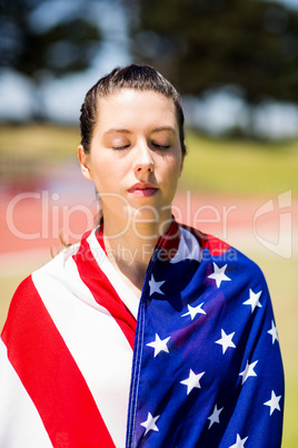 Female athlete wrapped in american flag