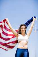 Female athlete holding an american flag