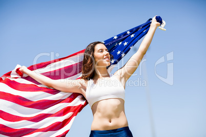 Female athlete holding an american flag