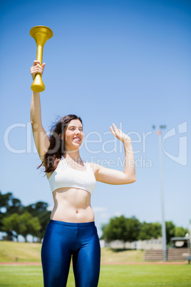 Female athlete holding a fire torch