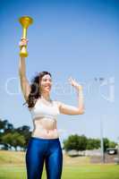 Female athlete holding a fire torch