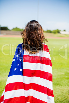 Female athlete wrapped in american flag