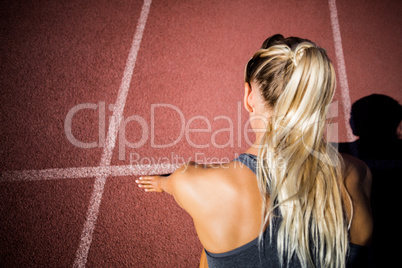 Female athlete ready to run on running track