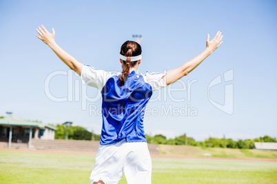 Rear view of soccer player posing after victory Rear view of soccer player posing after victory