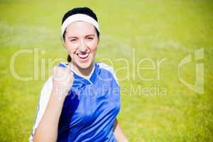 Happy soccer player posing after victory