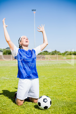 Excited soccer player posing after victory