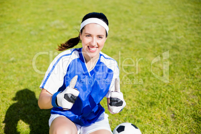 Happy soccer player showing her thumbs up