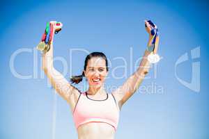 Happy female athlete showing her gold medals