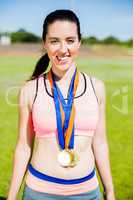 Female athlete with gold medals around her neck