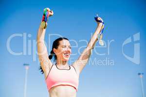 Female athlete showing her gold medals