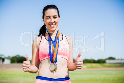 Female athlete with gold medals around her neck