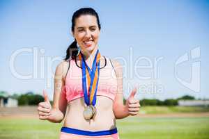 Female athlete with gold medals around her neck